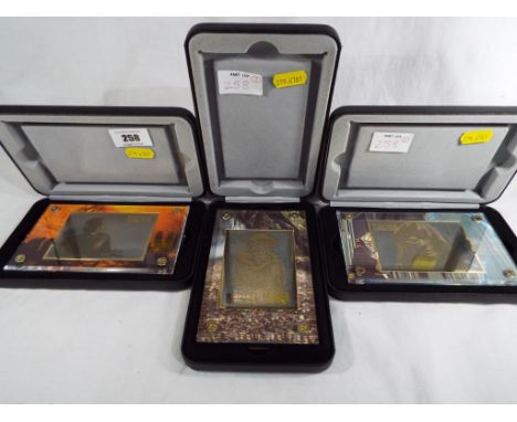 Star Wars - three Star Wars Trilogy 24k gold collectables from The Empire Strikes Back in their presentation cases, mint in b