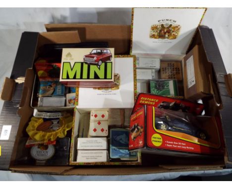 A good mixed lot to include a pocket meccano set, small quantity of die-cast model cars, a tin of vintage playing cards, a Ma