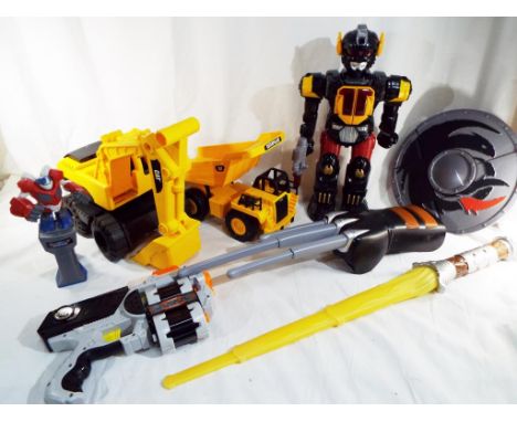 A mixed lot of boy's action toys to include two Caterpillar construction diggers, a large Chad Valley transformer toy, a swor