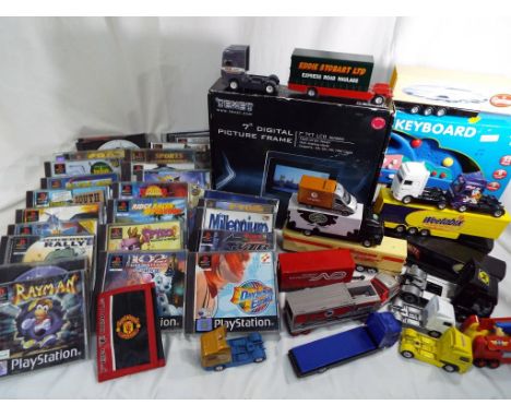 A mixed lot of children's toys to include a selection of Playstation games, Corgi diecast vehicles to include Weetabix, Ocado