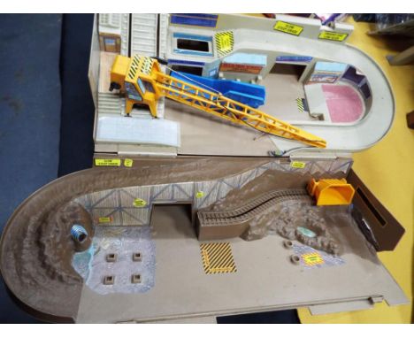 A Hot Wheels track by Mattel and a model castle with a drawbridge (2)