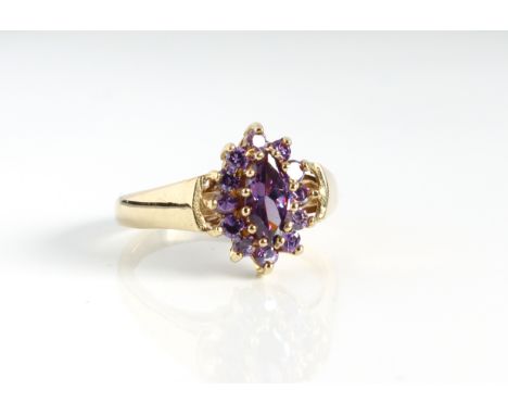 A 9ct yellow gold and purple stone cluster ring - probably amethyst, Birmingham hallmarks, the central marquise cut stone wit