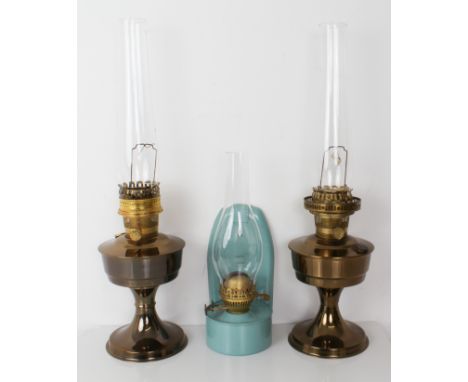 A pair of modern 'Aladdin' oil lamps and glass funnels, together with an earlier French style wall hanging lamp, and a crimpe