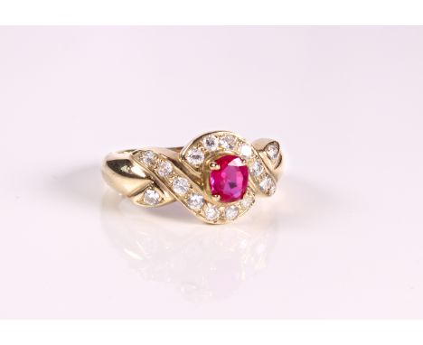 A 9ct yellow gold, pink and clear stone cluster ring - Sheffield hallmarks, with cross over setting, the clear stones probabl