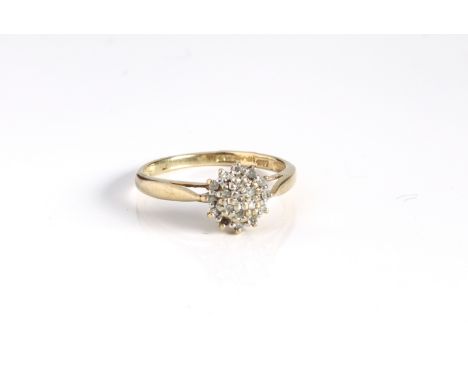 A 9ct yellow gold and diamond cluster ring - Sheffield hallmarks, with a domed circular cluster of eight cut diamonds over ta