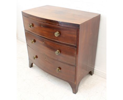 An early 19th century mahogany bowfront caddy-topped chest of small proportions: three full-width graduated drawers, shaped a