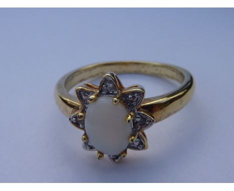 A silver gilt dress ring: centrally mounted with an oval opal (boxed), ring size R