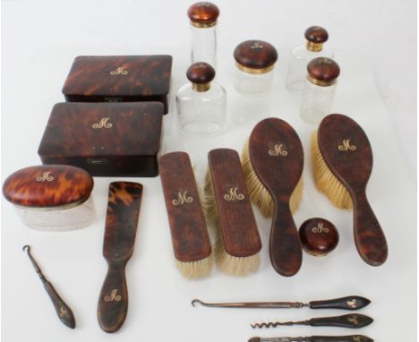 A lady's early 20th century tortoiseshell dressing table/vanity set to include: a pair of hairbrushes, a pair of clothes brus