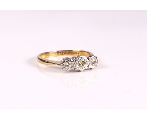 An 18ct yellow gold and diamond trilogy ring - stamped '18CT', with three graduated brilliant cut diamonds in bright cut illu