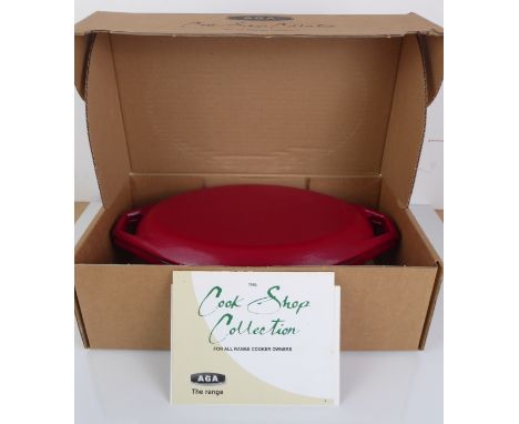 An original and unused cast iron Aga oval casserole with lid - from The Cook Shop Collection, in red enamel, 2.5 litre capaci