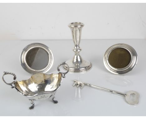 A silver selection to include - a pair of small circular hallmarked silver easel-style photograph frames, London mark 1919;&n