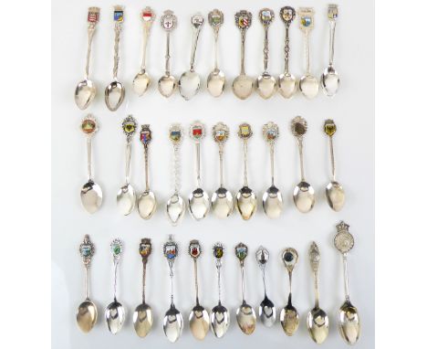 A small collection of silver-plated commemorative teaspoons: most with topographical enamel terminals.