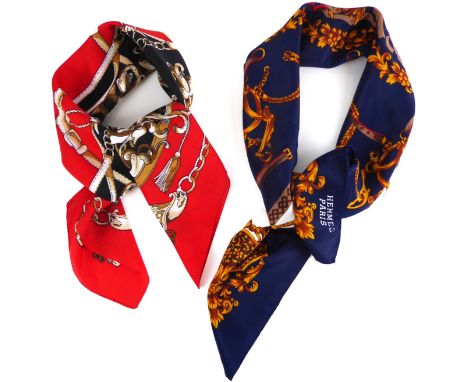 Two Herm&egrave;s-style scarves - one in dark blue, red and white with gold central foliate rosette and horse bridle style bo