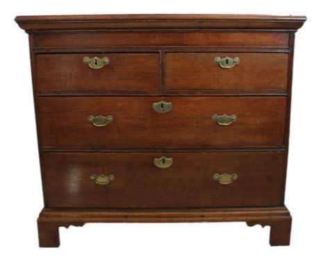 An early 18th century oak chest of small proportions - two-plank cleated moulded top, two half-width and two full-width gradu