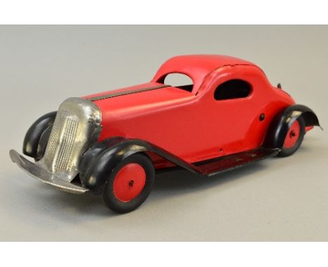 A MARX TINPLATE CLOCKWORK SALOON CAR, British made, red body and hubs, black chassis and wheelarches, bare metal grille and t