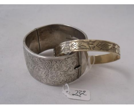 A vintage engraved silver bangle 3cm wide also a rolled gold bangle      