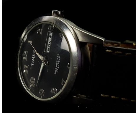 A Timex perpetual calendar wristwatch. Stainless steel, black dial with rectangular day and date apperture. 