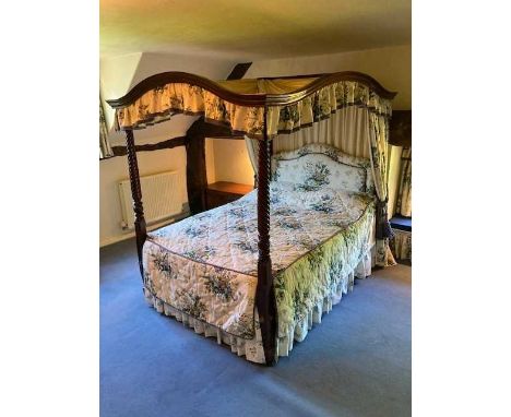 Mid 19th century mahogany framed four-poster bed, the arched canopy with pleated fabric, supported on carved writhen columns,