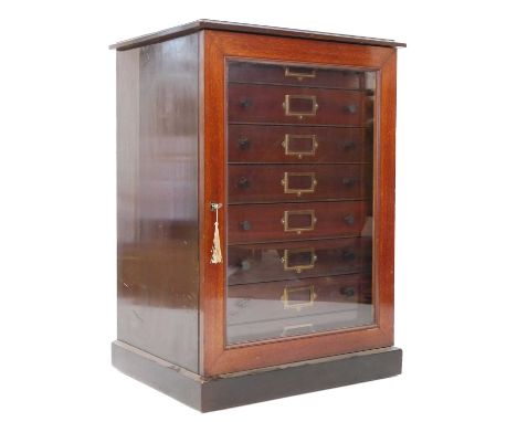 Collectors cabinet, glazed door revealing with eight drawers each fitted with name cardholder. 80cm x 57cm x 42.5cm.