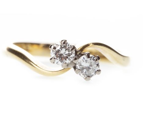 DIAMOND TWO STONE RING, the round brilliant cut diamonds totalling approximately 0.26 carats, in a twist setting, in eighteen