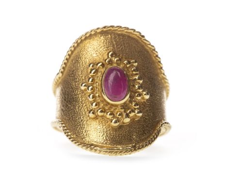 RED GEM SET RING, the oval bezel 23mm long set with central cabochon red gem, with ropetwist decoration to the edges, with ma