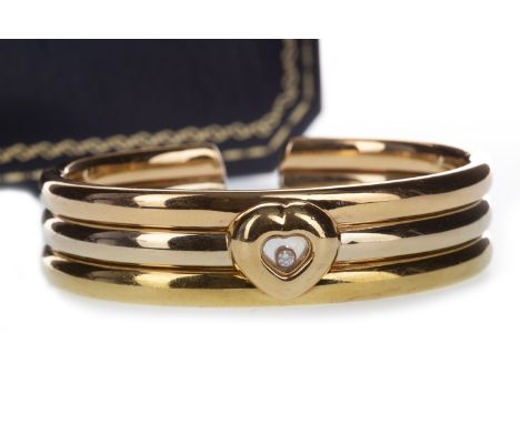 CHOPARD TRICOLOUR HAPPY DIAMONDS CUFF, 15mm wide with rose, yellow and white gold sections, the central heart with free movin