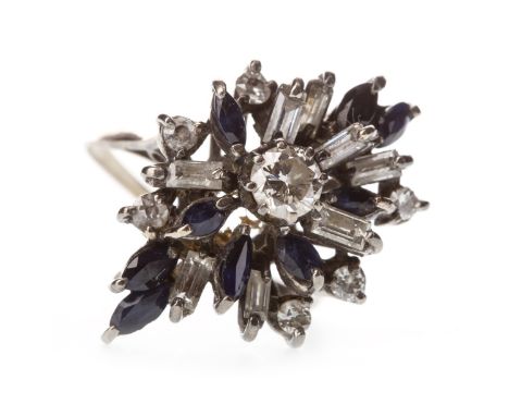 BLUE GEM AND DIAMOND CLUSTER RING, the central round brilliant cut diamond of approximately 0.38 carats, flanked by round and