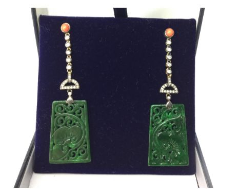 PAIR OF JADE, CORAL AND DIAMOND EARRINGS, each with a carved jade section suspended from a row of collet set diamonds, the di