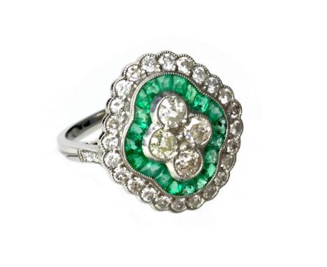 EMERALD AND DIAMOND RING, with four central round brilliant cut diamonds within a border of calibre cut emeralds, in turn bor