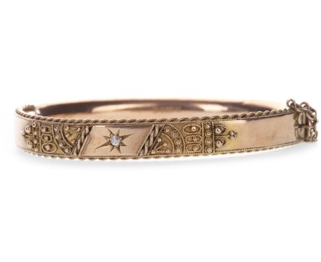 DIAMOND SET BANGLE, with central star set diamond of approximately 0.05 carats, flanked by ropetwist and spherical decoration