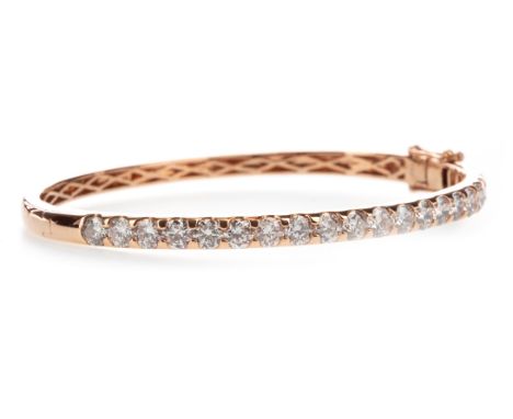 DIAMOND BANGLE, set with a row of round brilliant cut diamonds totalling approximately 4.21 carats, 58mm inner diameter, in r