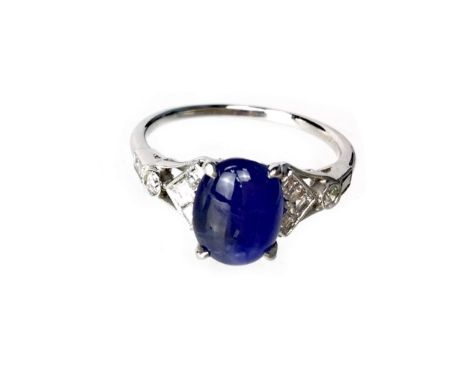 SAPPHIRE AND DIAMOND RING, the cabochon sapphire flanked by asscher, round and baguette cut diamonds to each shoulder totalli
