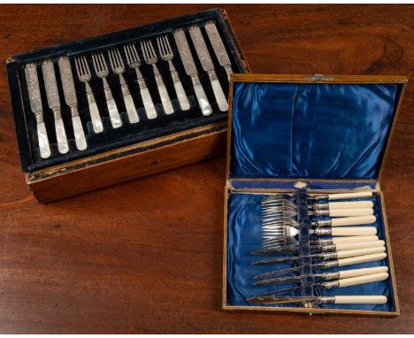 A small canteen of silver plated wares to include: twelve dessert spoons, the bowls decorated with motifs of fruit; twelve de
