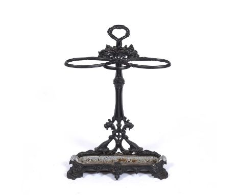 A Victorian black painted cast iron stick stand together with a collection of brass fire irons to include a set of three with