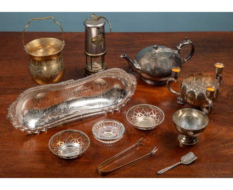 A collection of silver plated items to include a teapot; three dishes, two of which a pair of pierced; a glass cut candle hol