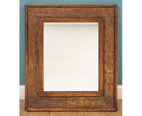 A modern gilt wall mirror, with scale ormament arround the bevelled mirror plate99cm wide x 114cm highQty: 1Minor marks and s