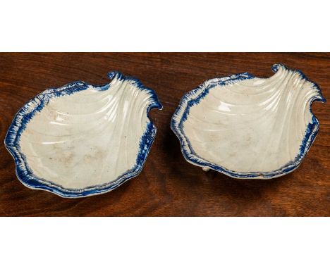 A pair of 18th century pearlware dishes of scallop form with tripod feetQty: 2Minor chipping to the rim and extremities, craq