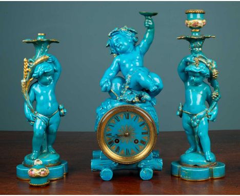 An early 20th century garniture de cheminée, the turquoise glazed pottery mantel clock in the form of a wine barrel surmounte