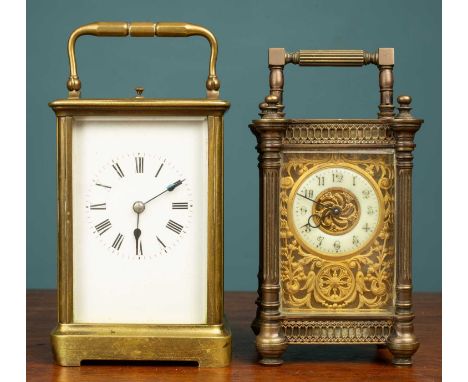 Two brass carriage clocks, the first a late 19th century French carriage clock with a gothic enamelled chapter ring and folia