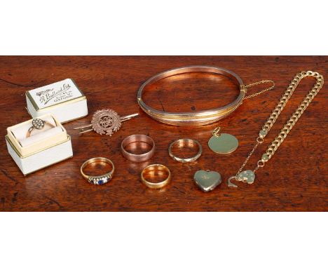 A collection of gold jewellery to include a gold-hinged bracelet; wedding bands and a military brooch; one wedding 22ct weddi