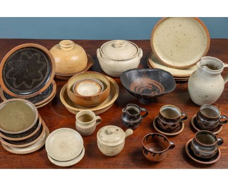 A collection of Winchcombe Studio pottery to include three mugs, two similar saucers and a milk jug; a tureen and cover; a mi