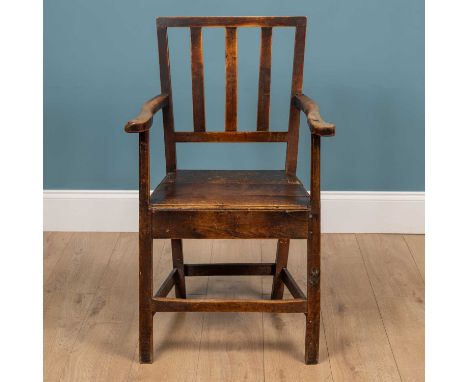 A Farmhouse style fruitwood chair with a stick back and a slatted seat, raised on square legs united by a stretcherQty: 1Some