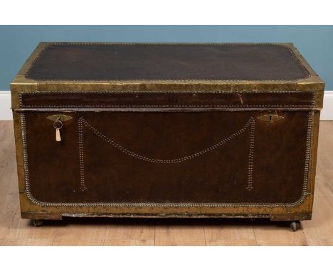 A camphorwood campaign trunk with leatherette covering and brass mounts, with twin locks to the front and on later castors112