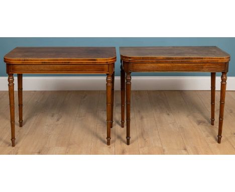 A near pair of Regency style mahogany D-end fold-over card tables with satinwood banding to the railings, all raised on ring 