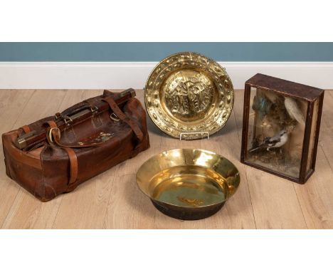 A brass alms dish depicting Adam and Eve eating from the Tree of Knowledge embossed with 'Detmer Ellmers 1713' surrounded by 