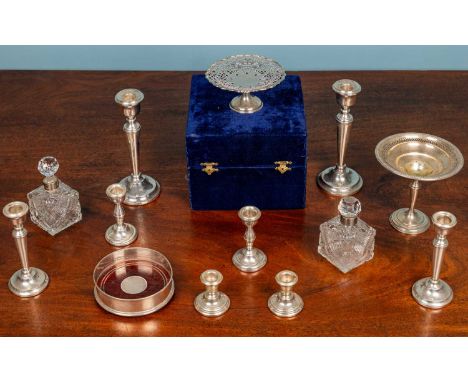 Silver and plate consisting of 4 pairs of silver candle sticks, a pierced silver tazza14.5cm diameter, a silver mounted bottl