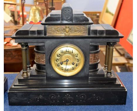 A large Victorian black slate clock, the gilt face with black numerals with four small Corinthian columns