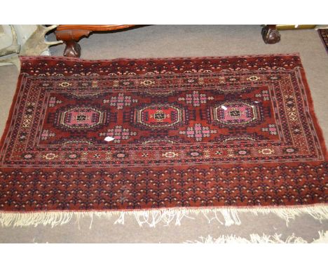 A Belouch wool wall hanging decorated with geometric patterns in red, blue and cream, 137cm wide (Item 67 on vendor list)