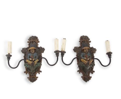 A pair of early 20th Century wall lights with central polychrome panel decorated with a Chinese gentleman and two adjustable 