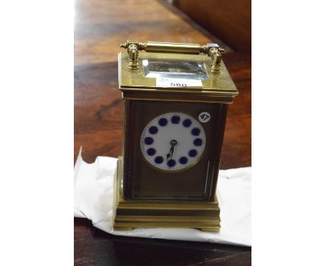 Late 19th or early 20th Century brass cased carriage clock with white and blue enamel dial with Arabic numerals and a brass m